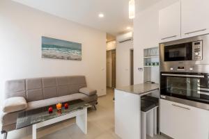 a living room with a couch and a kitchen at Apartment DeLux in Split +5 photos