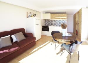 a living room with a couch and a table at Studio 177 in Matosinhos +29 photos