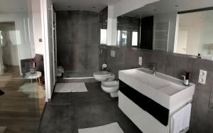 a bathroom with a white sink and a toilet at Apartment Central Würzburg in Würzburg