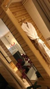 a bed in a room with a clothes rack at Le Grand Hotel in Maubeuge +45 photos