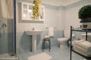 a bathroom with a sink and a toilet at Casa Albigiò in Catania +55 photos