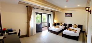 Giường trong phòng chung tại Champa Resort & Spa