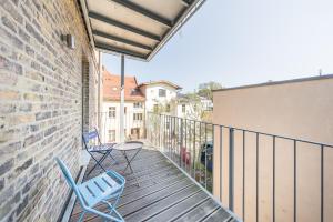 two blue chairs sitting on a balcony of a building at Design Apartments - "Potsdam West", 80 in Potsdam