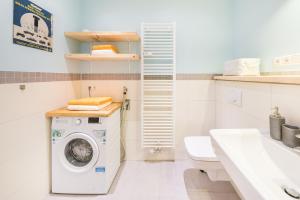 a washing machine in a bathroom with a sink at Design Apartments - "Potsdam West", 80 in Potsdam