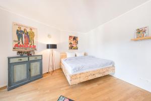 a bedroom with a bed and a dresser in it at Design Apartments - "Am Schloss" in Potsdam