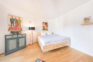 a bedroom with a bed and a dresser in it at Design Apartments - "Potsdam West", 80 in Potsdam