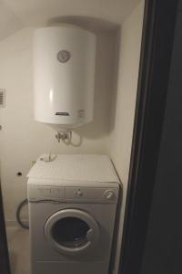 a small bathroom with a washing machine and a dryer at Villa Mary in Torre Lapillo
