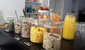 a table with jars of different types of food at Boutique-Hotel Kronenstuben - unschlagbare Zentrumsnähe direkt am Marstall & Marktplatz - Schloss in 3 Min - Frühstück - Langzeitmiete in Ludwigsburg