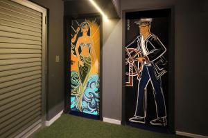 a door with a painting of a man and a woman at Cris Hotel in Florianópolis