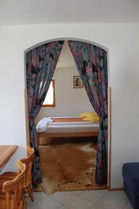 a bedroom with a bed in a room with a window at Apartma Ana in Bavšica