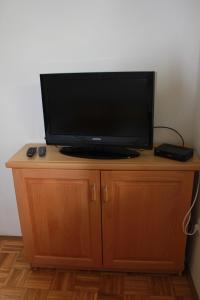 a flat screen tv sitting on top of a wooden cabinet at Apartma Ana in Bavšica