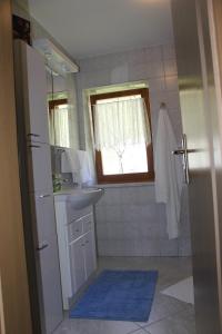 a bathroom with a sink and a mirror at Apartma Ana in Bavšica