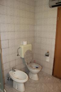 a small bathroom with a toilet and a bidet at Apartma Ana in Bavšica