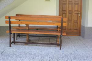 a wooden bench sitting in front of a door at Apartma Ana in Bavšica