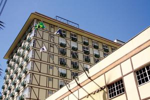 a building with flags on the side of it at Estudio Itaipava in Itaipava