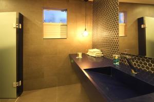 a bathroom with a black sink and a mirror at Cris Hotel in Florianópolis
