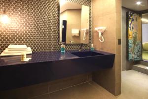 a bathroom with a black sink and a mirror at Cris Hotel in Florianópolis