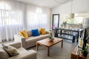 a living room with a couch and a table at Ocean Palms Residences in Cabarete