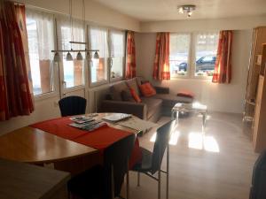 a living room with a table and a couch at Chalet Sunstar in Saas-Grund