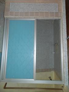 a window in a bathroom with a shower at Posada Joan Sebastian in Taxco de Alarcón