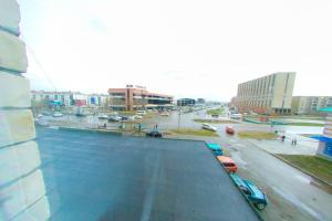 a view of a city street with cars on the road at Apart Auezov street City Centr in Ustʼ-Kamenogorsk +1 photo