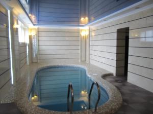 a jacuzzi tub in the middle of a house at Warszawa Hotel in Lviv
