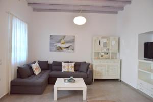 a living room with a couch and a table at Christina's Luxury Village House in Plaka Milou