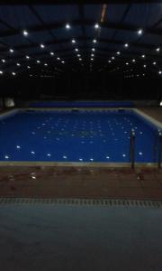 a large swimming pool in a building at night at Casa Rural Landa in Galbarra