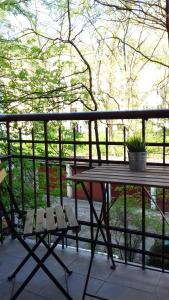 a picnic table and a bench on a porch at SL apartments in Kraków