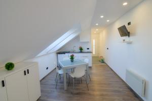 a kitchen and dining room with a staircase in a loft at Apartment Harmony in Ljubljana
