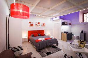 a bedroom with a bed with red pillows and a table at B&B La Casetta in Cerignola