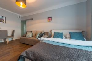 Łóżko lub łóżka w pokoju w obiekcie Dworzec Centralny P&O Serviced Apartments