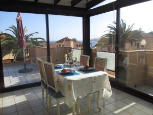 a dining room with a table and chairs on a balcony at Ferienhaus Vista Mar in Costa Calma