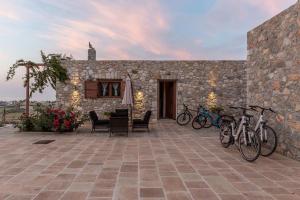 a patio with bikes parked in front of a stone building at Grand View Villa in Kardamaina