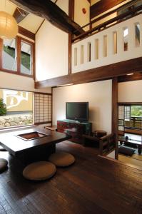 a living room with a table and a tv at Katsuragi no Sato in Takayama