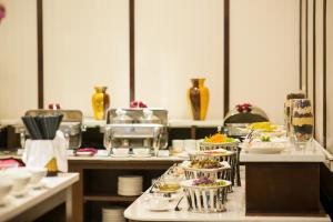 a buffet line with plates of food in a restaurant at Muong Thanh Hanoi Centre Hotel in Hanoi