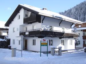 a large white building with a balcony in the snow at Haus Irmgard by Châtel Reizen in Tux