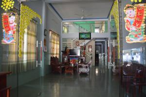 a hallway of a building with a table and chairs at Minh Ha Hotel in Lagi