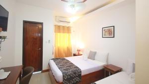 Postel nebo postele na pokoji v ubytování El Nido Royal Palm Inn