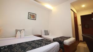 Postel nebo postele na pokoji v ubytování El Nido Royal Palm Inn