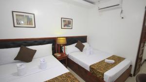 Postel nebo postele na pokoji v ubytování El Nido Royal Palm Inn