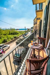 a table and chairs on a balcony with a view of a street at Villa Favorita Suites in Ercolano