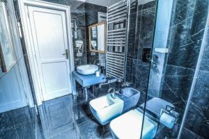 a bathroom with a sink and a toilet and a shower at Villa Favorita Suites in Ercolano +40 photos