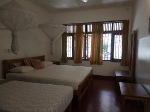 Postel nebo postele na pokoji v ubytování Hotel Mango Garden + 37 fotografií