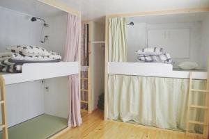 a room with two bunk beds and a window at Kichinan in Osaka