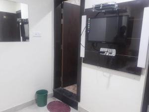 a room with a tv on a wall at Hotel Arzoo Palace in Ajmer