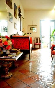 a living room with a red couch and a table at Albergo Boutique Casajanca in Canneto