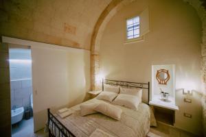 A bed or beds in a room at B&B Antichemura