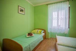 Postel nebo postele na pokoji v ubytování Apartments Dabović