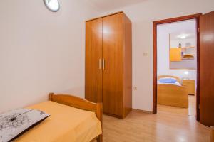 Postel nebo postele na pokoji v ubytování Apartments Dabović